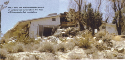 photo of quake-damaged house with caption